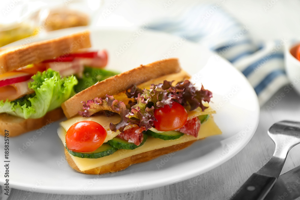 Plate with delicious sandwich on table, closeup Plate with delicious sandwich on table, closeup