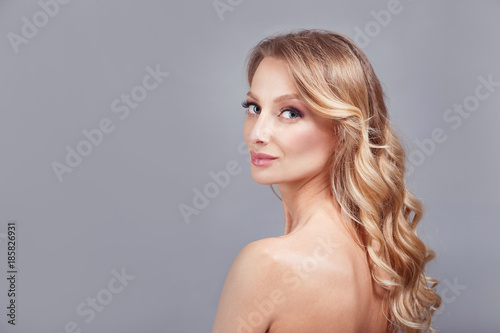 sensual fashion closeup portrait of young pretty woman blond on gray background.