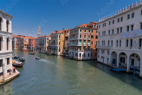 Magnificent daily view of Gondola with classical buildings along the famous Grand canal in Venice, Italy © djevelekova