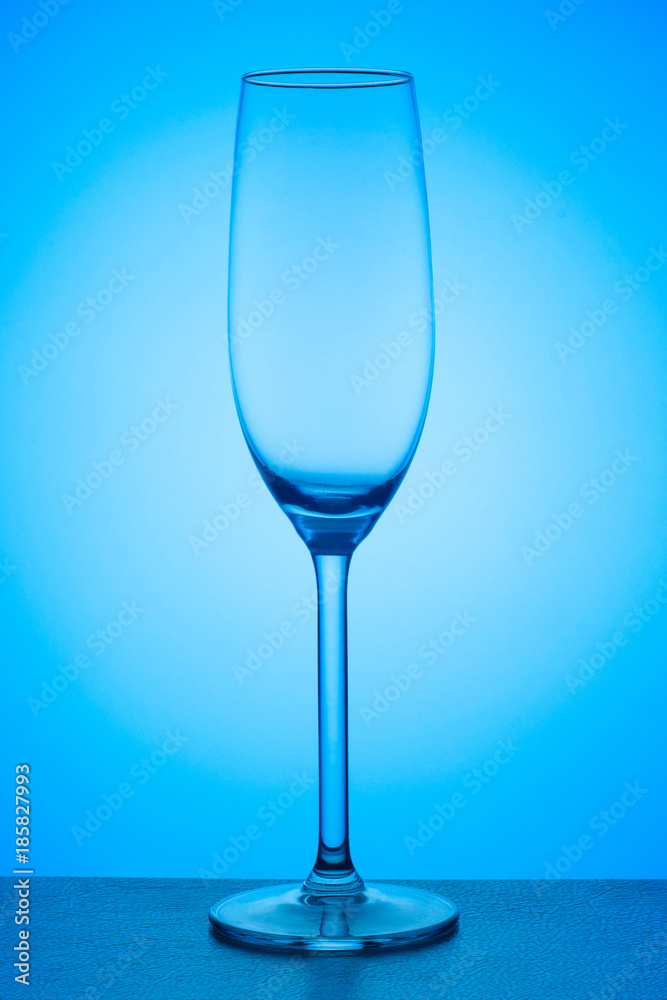 Closeup view of champagne glass on a blue gradient background Closeup view of champagne glass on a blue gradient background