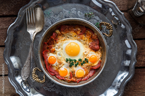 Top view of fried eggs with cured meat, turkish breakfast pastirmali yumurta photo