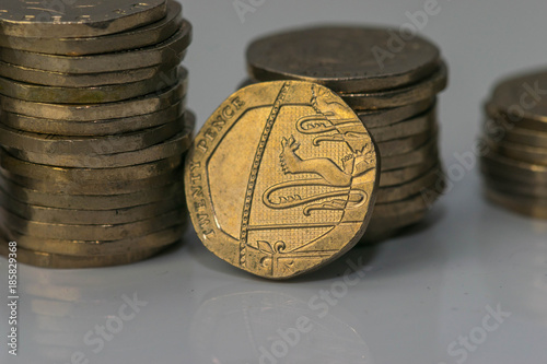 Stacks of different British coins on a white background. photo