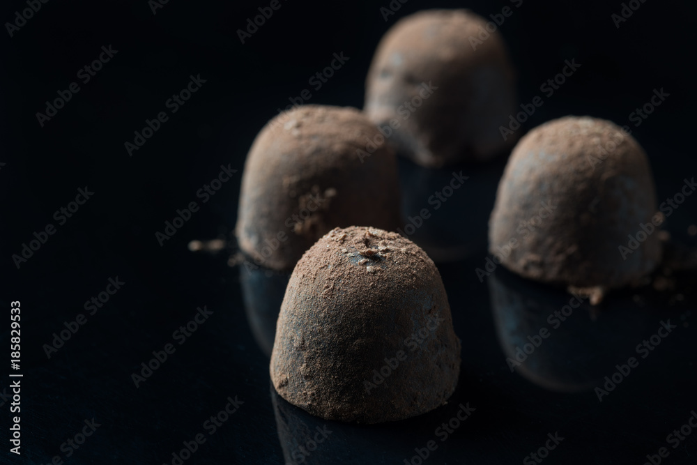 Homemade truffle chocolate candies with cocoa powder made by chocolatier Homemade truffle chocolate candies with cocoa powder made by chocolatier