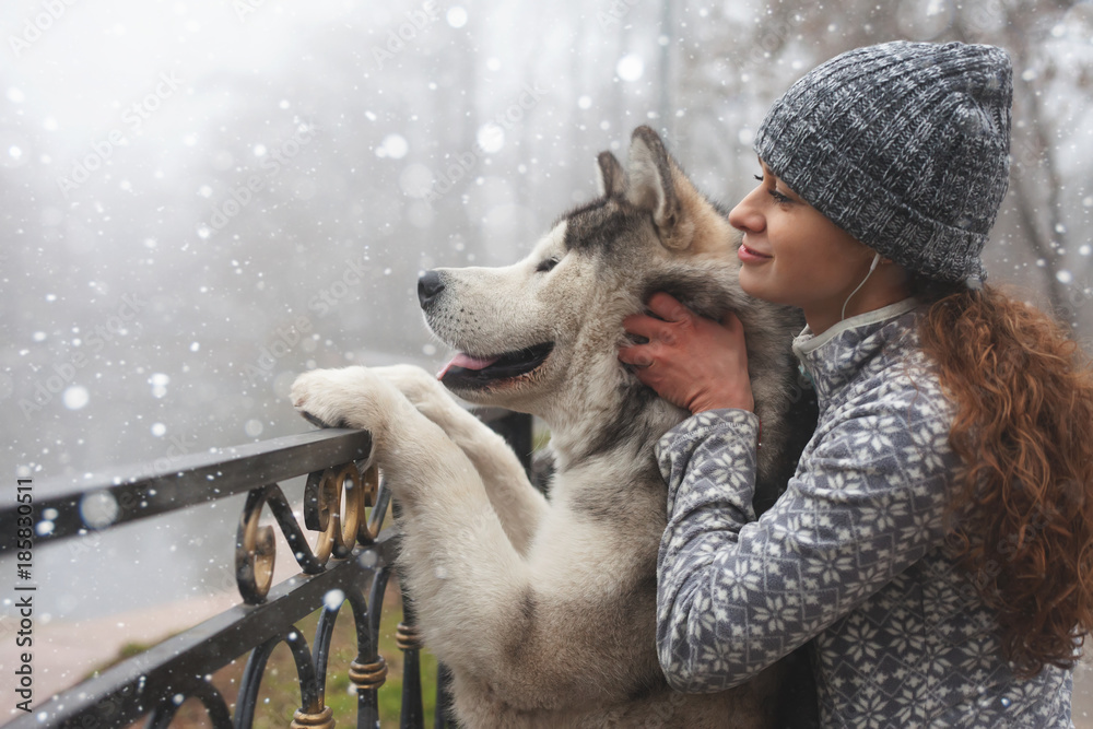 Image of young girl with her dog, alaskan malamute, outdoor Image of young girl with her dog, alaskan malamute, outdoor