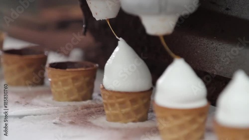 Ice cream production line. Filling of wafer cups with ice cream. Ice cream in a cone. Ice cream factory.
