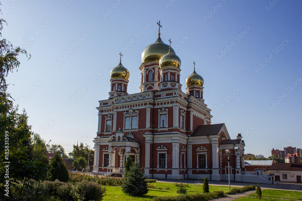 Church with domes in Russia, against the blue sky. Temple with golden domes. Majestic architecture with ancient history.