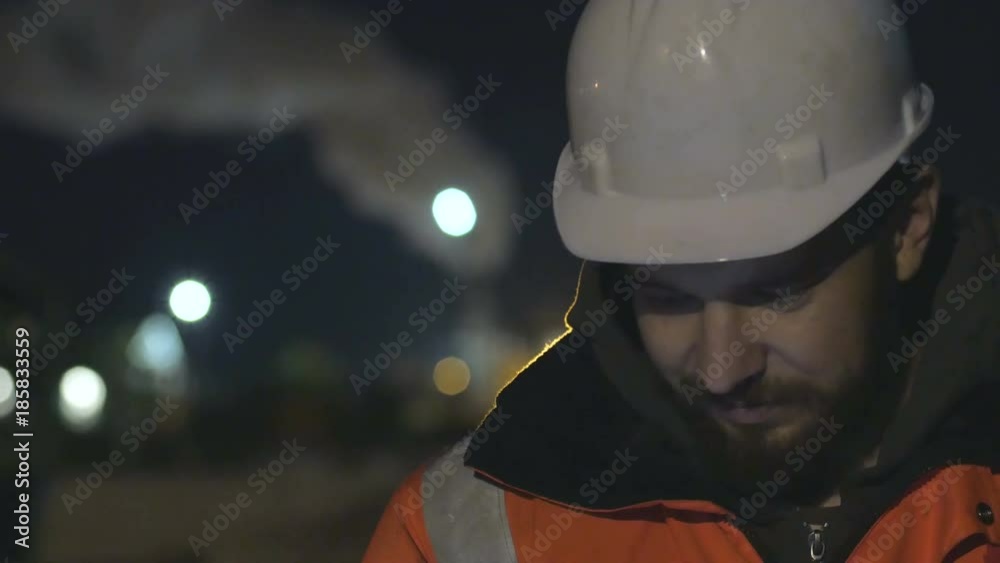 Close up shot of worker using smartphone in the twilight. Night shift concept.4k