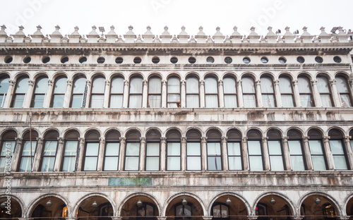 Arcades of the facade on Piazza San Marco ,Saint Mark square, in Venice, Italy, Famous places of Venice Italy Piazza San Marco, Window of building in Venice. photo