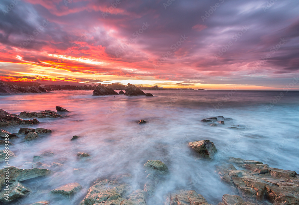 Obraz premium spectacular and colorful sunset on the beach of Arnao