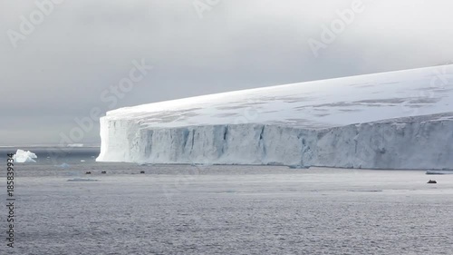 Islands along British channel. Glaciers, icefall, outlet glacier, snowfields, iceberg and rock outcrops. Tourists disembark to glacier 50 meters on island of Champa. Franz Joseph Land
 photo