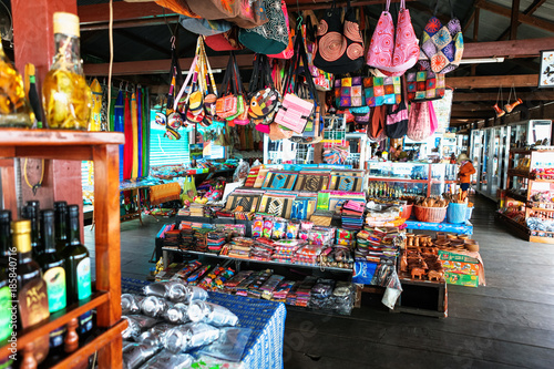 beautiful and colourful silk and cotton Indian scarfs, bags and bottles sold in souvenir shop market stall