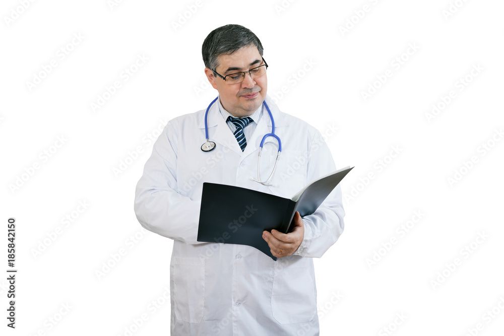 Handsome male doctor reads the diagnosis in a workbook Handsome male doctor reads the diagnosis in a workbook