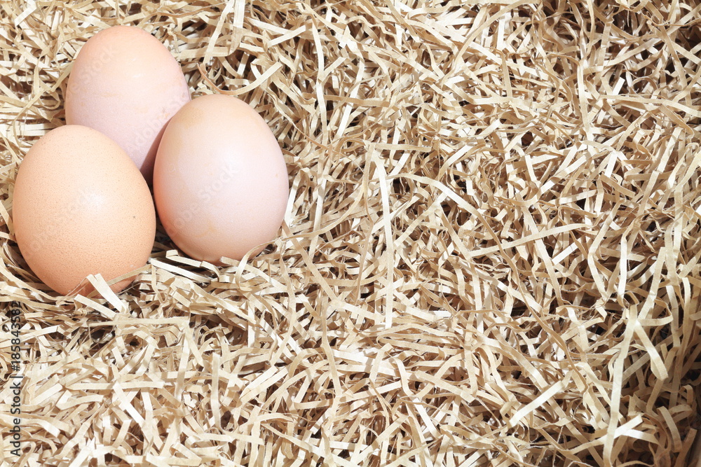 Brown eggs in box or crates and some straw made of paper. shallow depth of field. Brown eggs in box or crates and some straw made of paper. shallow depth of field.