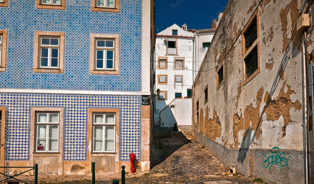 Contrasting shot of an empty street in Alfama, the oldest district of Lisbon, Portugal, on the slope of Sao Jorge. Alfama boasts many historical attractions along with Fado bars and restaurants.