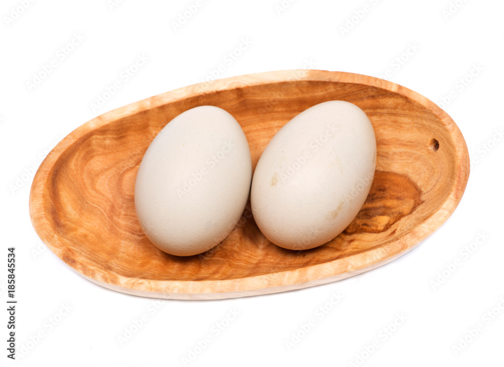 Unwashed fresh organic gmo and soy free pasture raised chicken eggs in wooden bowl isolated on white background Unwashed fresh organic gmo and soy free pasture raised chicken eggs in wooden bowl isolated on white background