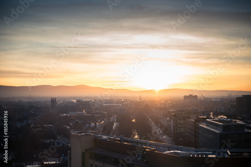 Dublin cityscape at sunset, office buildings, churches, mountains in twilight 