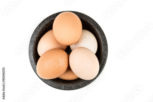 Farm fresh eggs in a bowl on a white background