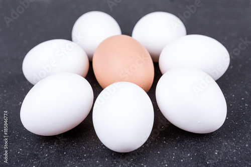 Farm fresh and commercial eggs on a black background