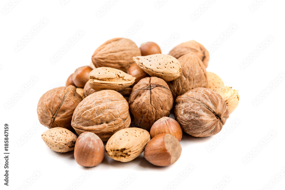Mixed nuts in shell on a white background Mixed nuts in shell on a white background