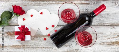 Valentines wine with gifts on rustic wooden background