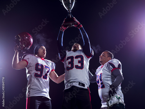 american football team with trophy celebrating victory © .shock