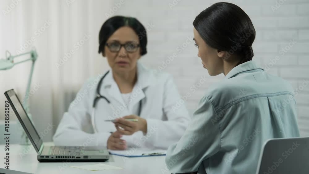 Female doctor informs about bad diagnosis, patient upset, incurable disease Female doctor informs about bad diagnosis, patient upset, incurable disease