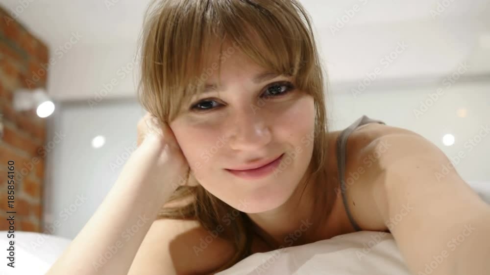 Woman Taking Selfie in Bed, Front Camera View