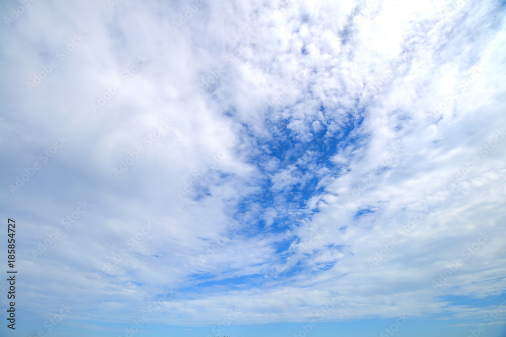 The blue sky and motion white fluffy clouds