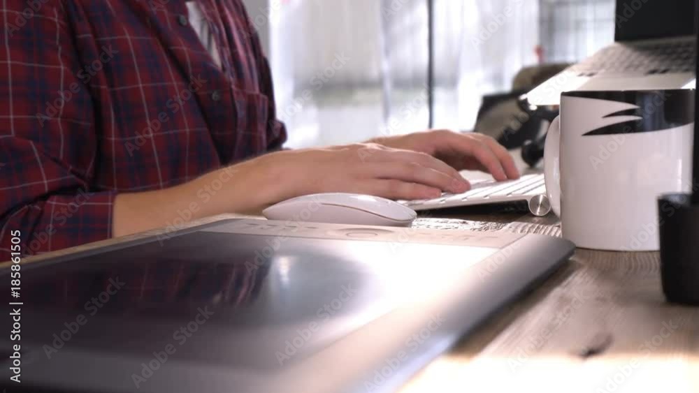 Zoom in the hands typing on white keyboard Zoom in the hands typing on white keyboard