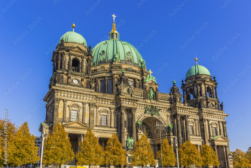 Berlin Cathedral ( Berliner Dom) on the Muzeum Island . Blue sky and yellow leaves on the trees.Berlin , Germany.