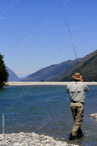 Fly Fisherman Setting Hook on River in Otago South Island New Zealand