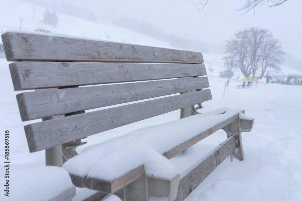 Bench covered with snow in winter ski resort Stock Photo | Adobe Stock