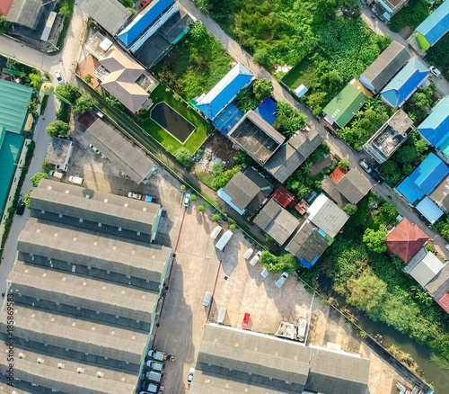 Buildings taken from a high angle.The two sides differ. One side is buildings and nature, and the other side is the industry factory.