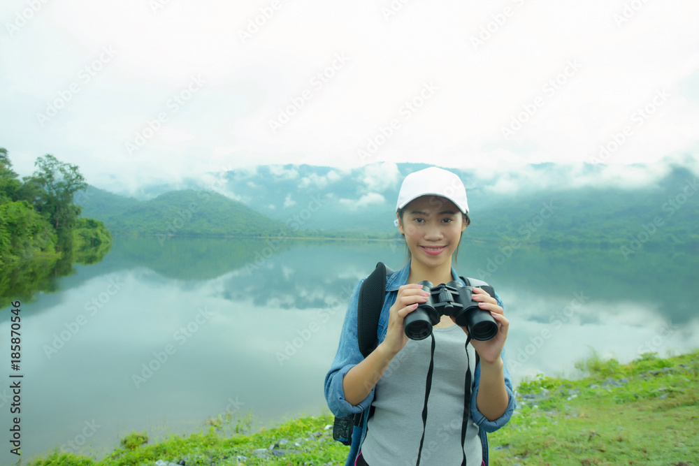 Thai adventure girl happy and holding a binoculars