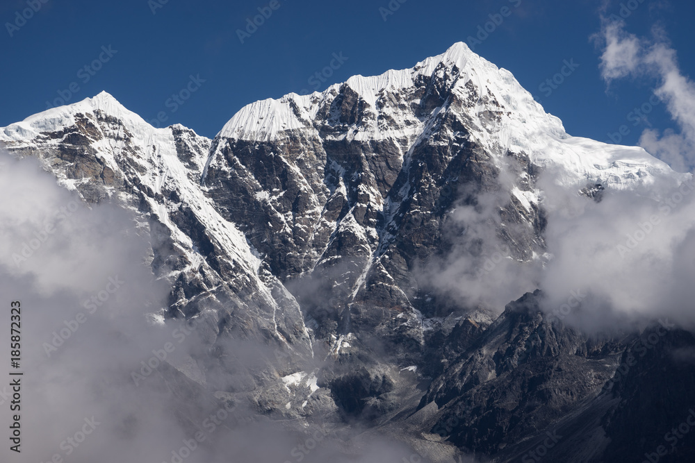 Taboche mountain peak above the clouds, Everest region, Nepal