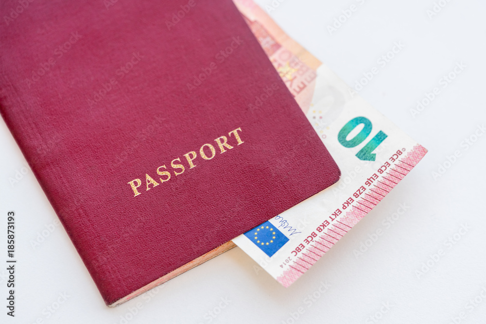 10 euros in the red passport on a white background, close-up 10 euros in the red passport on a white background, close-up