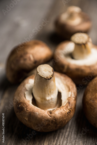 Fresh mushrooms on the rustic wooden background. Selective focus. Shallow depth of field.