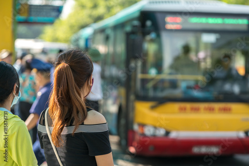 Young girl waiting for bus at bus station. Closeup.