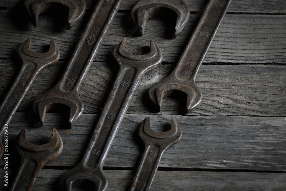 Dirty set of hand tools on a wooden background. Old rusty tools Sales tools for assembly workers. Old shop Old working. Vintage working tools (drill, saw, ruler and others) on wooden background Dirty set of hand tools on a wooden background. Old rusty tools Sales tools for assembly workers. Old shop Old working. Vintage working tools (drill, saw, ruler and others) on wooden background