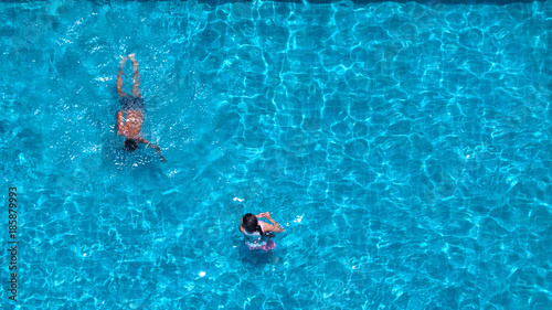 People swimming in the hotel pool on summer day