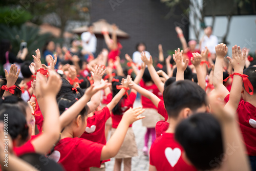 School children raising hands up on celebration day