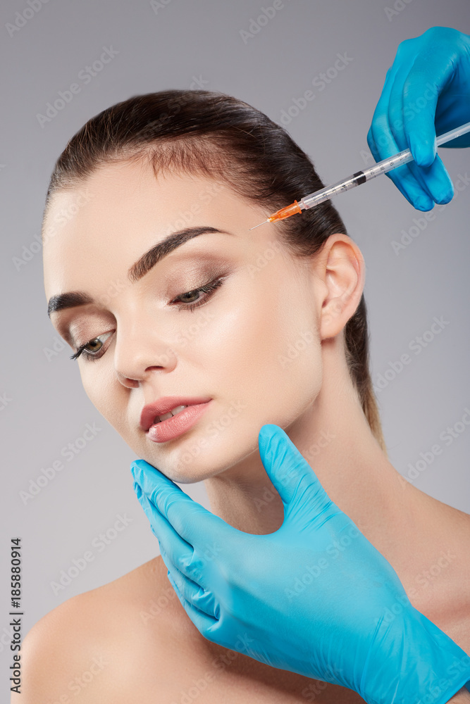 Cute girl doing beauty procedures at clinic