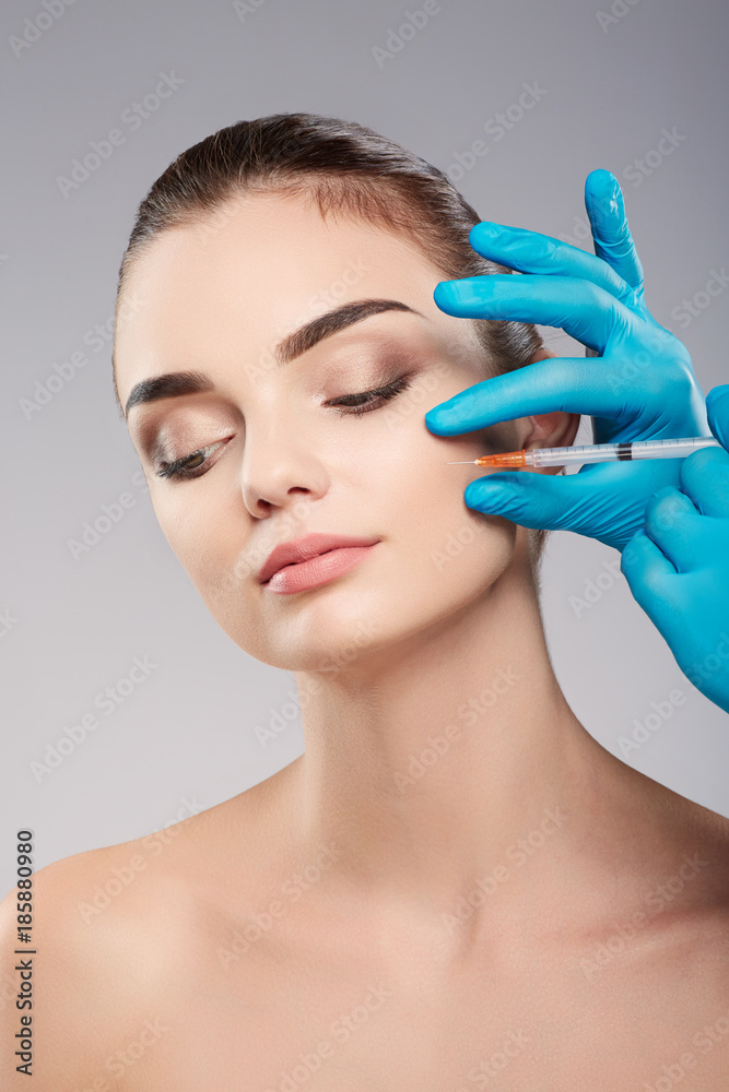 Cute girl doing beauty procedures at clinic