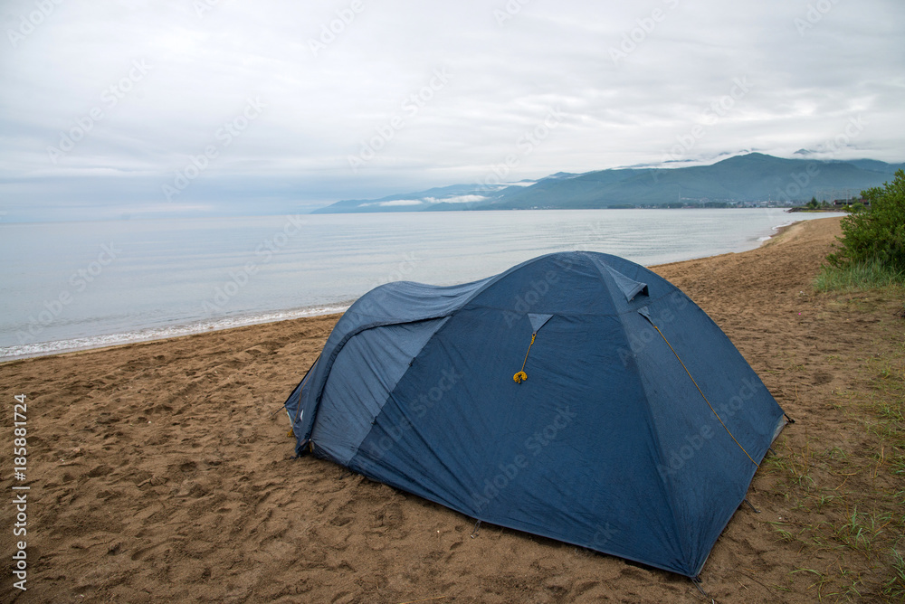 Tourist tent on the shore of Lake Baikal, Cloudy weather after rain.