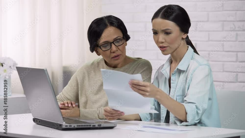 Family reading bill with big sum of money, unpleasant surprise, personal loan Family reading bill with big sum of money, unpleasant surprise, personal loan