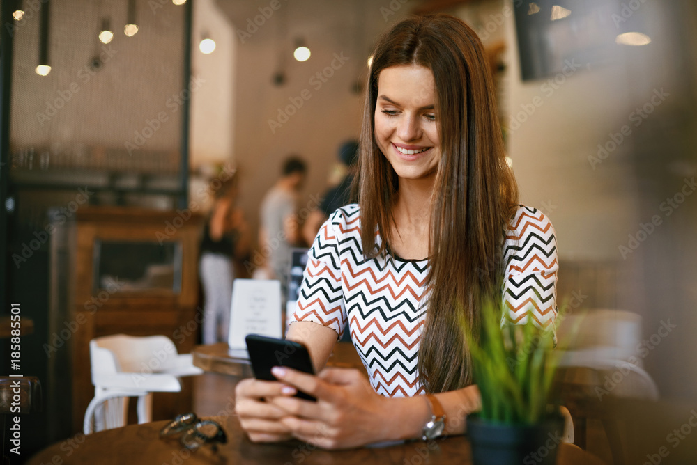 Beautiful Woman With Phone In Cafe. Beautiful Woman With Phone In Cafe.
