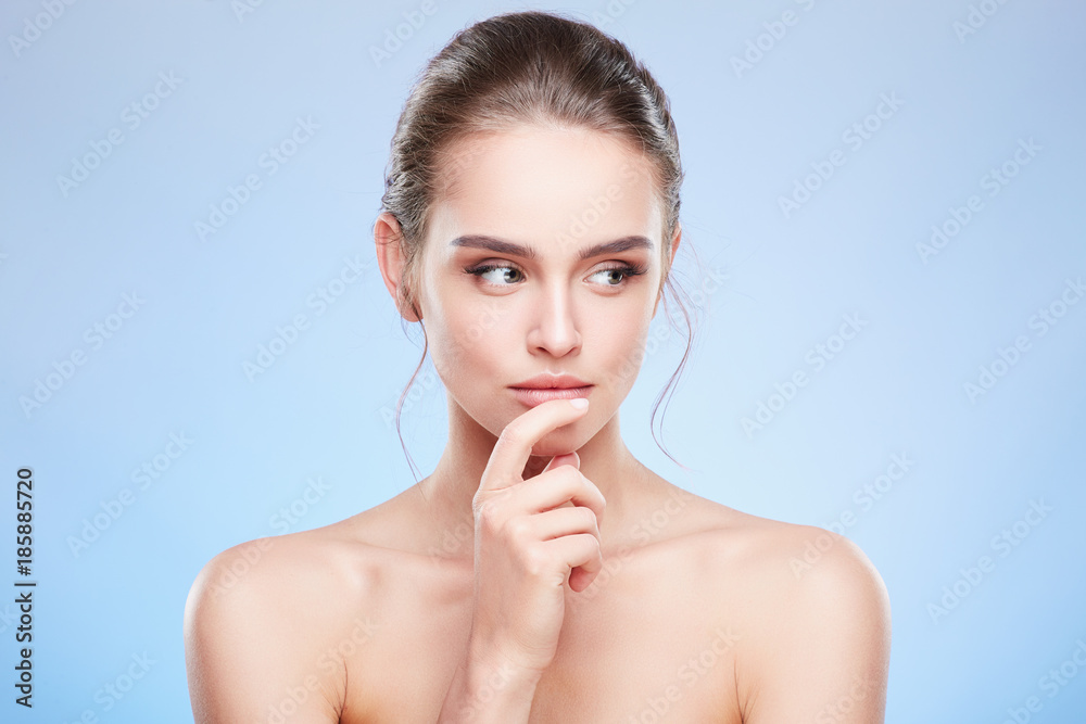 Woman touching lower lip and looking aside slyly Woman touching lower lip and looking aside slyly