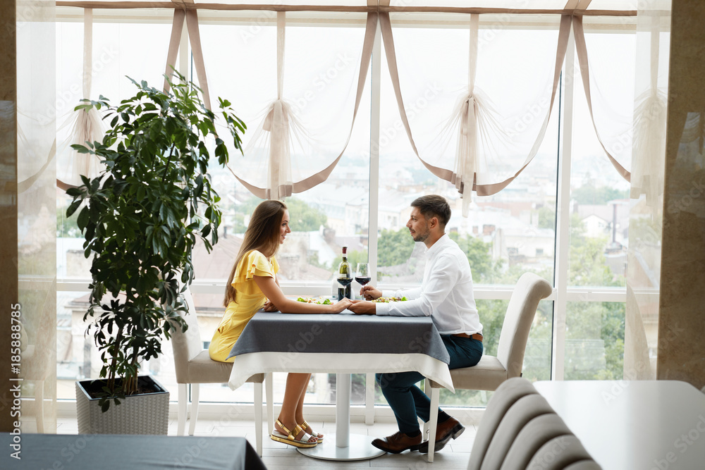 Beautiful Couple In Love On Romantic Date In Restaurant. Beautiful Couple In Love On Romantic Date In Restaurant.