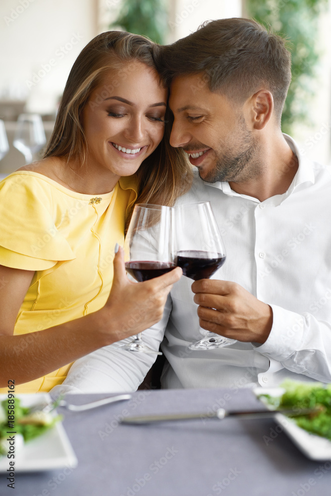 Couple In Love Drinking Wine In Restaurant. Couple In Love Drinking Wine In Restaurant.