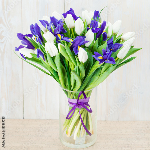 Fototapeta Naklejka Na Ścianę i Meble -  bouquet of white tulips and blue irises on a wooden background